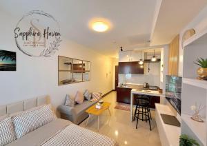 a living room with a couch and a kitchen at Sapphire Haven at Grand Residences Cebu East Tower B in Cebu City