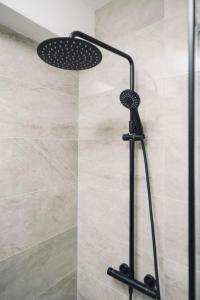a shower with a shower head in a bathroom at Carpe Diem in Raslina +18 photos