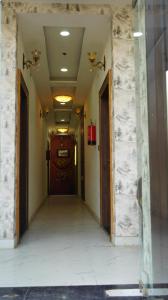 an empty hallway with a door in a building at Hotel Radhika's Inn in Mathura +7 photos