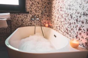 a bath tub filled with snow and candles in a bathroom at Villa Altrove in Montemarciano +32 photos