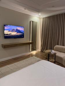a hotel room with a bed and a couch at Suits guys in Al-ʿUla