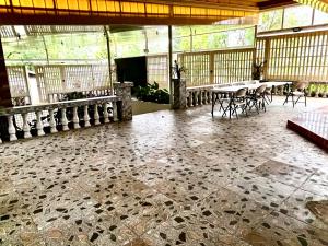 a room with tables and chairs in a building at BALAI BANAHAW Vacation Farm and Private Resort in Lucban