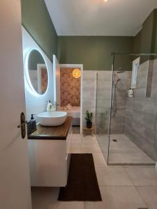 a bathroom with a sink and a shower at Blue Sky Apartments Pythagorion in Pythagoreio +10 photos