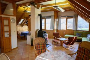 a living room with a couch and a table and chairs at Essence Apartman Tokaj in Tokaj