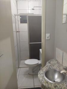 a small bathroom with a toilet and a sink at Hotel Porto Amazônia in Porto Velho