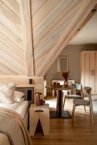 a bedroom with a bed and a table in a room at Villa Las Apartamenty in Zakopane