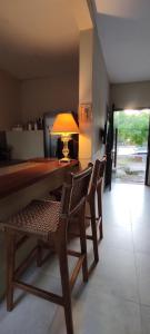 a dining room with a table with chairs and a lamp at Casa Bella vista in Paysandú