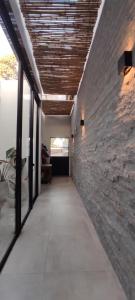 a hallway with a stone wall and a ceiling at Casa Bella vista in Paysandú