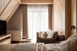 a bedroom with a bed and a window at Villa Las Apartamenty in Zakopane
