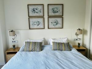 a bedroom with a blue bed with two pillows at Casa Solina in Islantilla