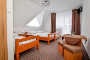 En eller flere senge i et værelse på Willa Kamila