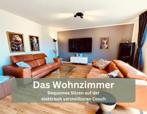 a living room with a couch and a tv at Lounge94 - Luxus auf 180 m2 in Wilhelmshaven