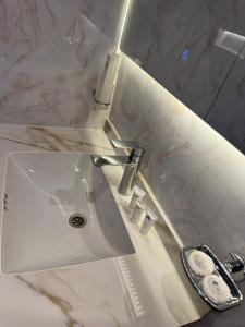 a white sink in a bathroom with a mirror at Suits studio in AlUla