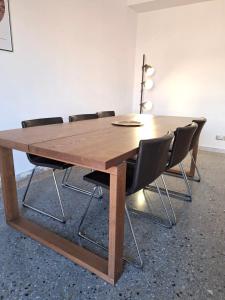 a wooden table with chairs around it in a room at Monti View Apartment in Rome +32 photos