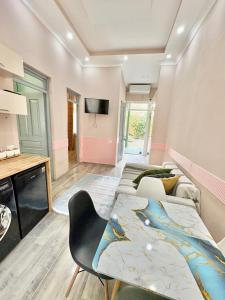 a living room with two beds and a tv at Tonik in Tbilisi City +12 photos