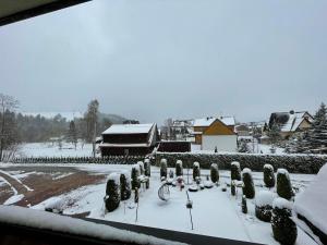 a yard covered in snow with a bike parked in it at Maniek in Białka Tatrzanska
