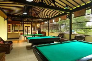 a billiard room with four pool tables in it at Plengkung Lodge G-Land in Ringinpintu