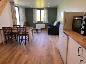 a kitchen and living room with a table and chairs at Les Galets 2 in Auchonvillers