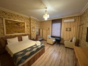 a bedroom with a bed and a desk and chairs at Safir Hotels Silivri in Silivri