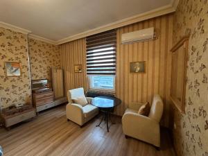 a living room with two chairs and a table at Safir Hotels Silivri in Silivri