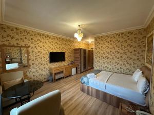 a hotel room with a bed and a television at Safir Hotels Silivri in Silivri