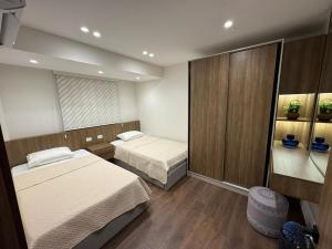 a small room with two beds in a room at جناح فندقي بغرفتي نوم 5 نجوم في المهندسين 10b Deluxe Suite in Cairo