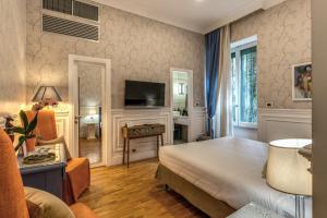TV a/nebo společenská místnost v ubytování Mangili Garden Hotel