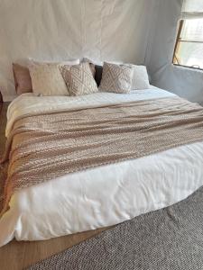 a large white bed with pillows on top of it at Bamboo Villas Huahin #1 in Hua Hin