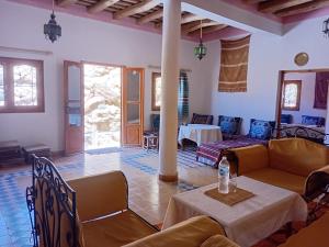 a living room with couches and a table at Hotel Source De Dades in Boumalne Dades