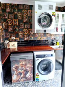 eine Küche mit einer Waschmaschine und einer Wandplatte in der Unterkunft Bettys Mountain Cottage in York + 31 Fotos