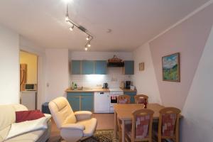 a kitchen and a living room with a table and chairs at Ferienvilla Drechsler in Pockau