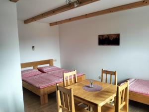a dining room with a table and a bed at U svaté Rozálie in Horní Věstonice +42 photos
