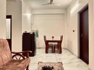 a living room with a couch and a table at Skye by livNstay in Trivandrum