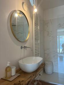 a bathroom with a white sink and a mirror at Casa MauRo in Senigallia +31 photos