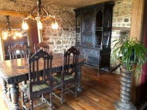 a dining room with a wooden table and chairs at 224 Rue St Martin in Montbray