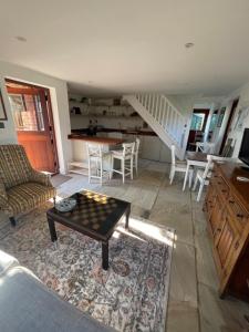 a living room with a coffee table and a staircase at The Old Poor House Coach House in Sidlesham