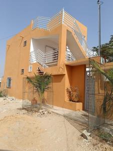 a house with a fence in front of it at Villa Aria in Mbour
