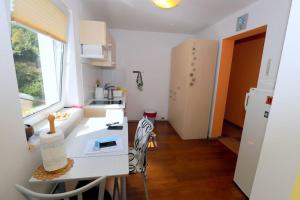 a kitchen with a white counter and a refrigerator at BledRoom in Bled