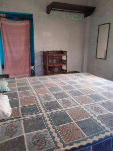 a bedroom with a large bed with a tiled floor at Ganga river House in mayapur