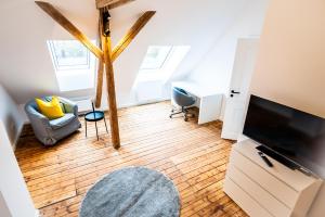 un soggiorno con TV a schermo piatto e pavimento in legno di 5 - mega saniertes Apartment im Dankmalschutz - nur kurze Zeit verfügbar a Brunsbüttel