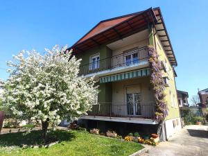 a building with a flowering tree in front of it at Le Aquile in Ghedi
