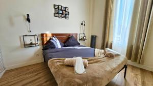 ein Schlafzimmer mit einem Bett und einem Handtuch darauf in der Unterkunft L'Ecorce - petit cocon à quelques minutes de Paris in Aubervilliers