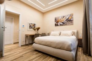a bedroom with a bed and a desk at Paci Luxury Suite in Rome