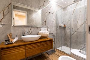 a bathroom with a sink and a shower at Paci Luxury Suite in Rome +14 photos