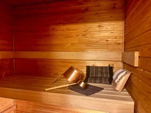 a sauna with a bench in a wooden wall at Nordic Sauna Experience in Helsinki