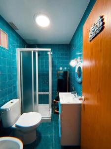 a blue bathroom with a toilet and a sink at Blue Vibes, Relax & Beach in San Javier +9 photos