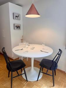 a white table with wine glasses and two chairs at Nordic Sauna Experience in Helsinki +10 photos