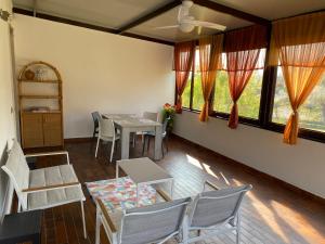a dining room with a table and chairs and windows at Appartamento Trifoglio in Salò