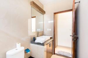 a bathroom with a toilet and a sink and a mirror at Rena's Kubu in Saba +13 photos