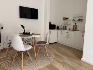 a kitchen and dining room with a table and chairs at Central - Cozy Studio in Arad +25 photos
